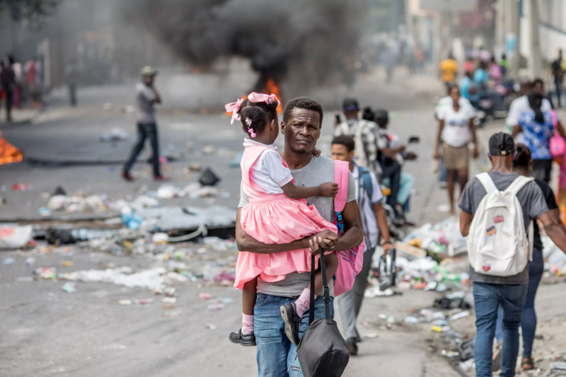 Photo Of Haitian Man Carrying His Daughter 800x533 1